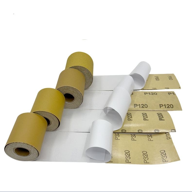 Hand-torn yellow adhesive sandpaper roll